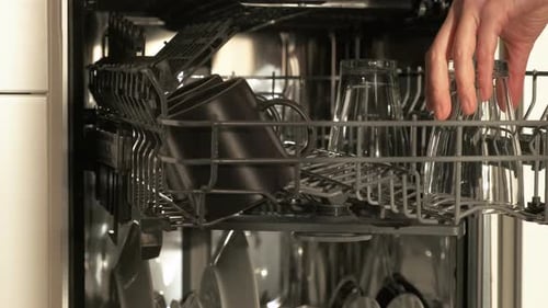 Unloading Clean Dishes From Stainless Steel Dishwasher