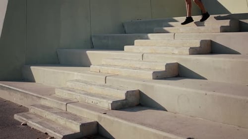 Man Exercising by Running Down Concrete Urban Steps
