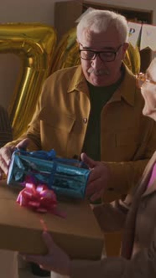 Seniors Receiving Gifts at Happy Birthday Party