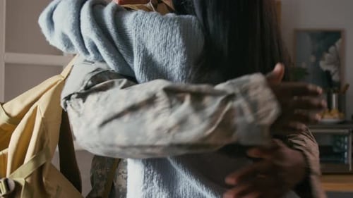 Woman Hugging Soldier in Warm Home Interior