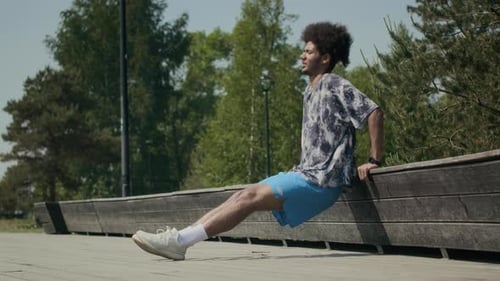Young Man Performing Bench Dips Outdoors in Park