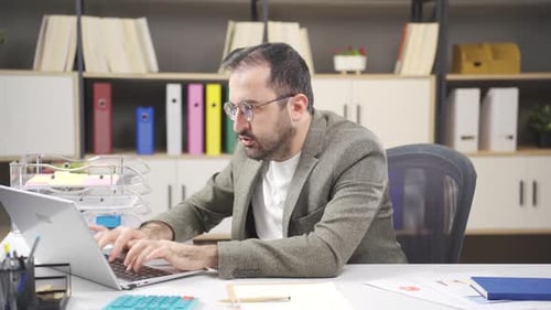 Man Working at Computer in Bright Office