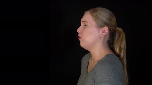 Side view of coughing woman. The woman has difficulty breathing. He is choking because of a cough. T