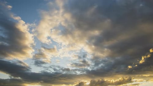 Golden Clouds Moving Across a Blue Sky