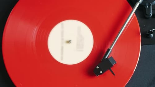 Red Vinyl Record Spinning on Turntable Close Up