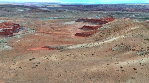 Flight over the rocky landscape with some red geological formations.