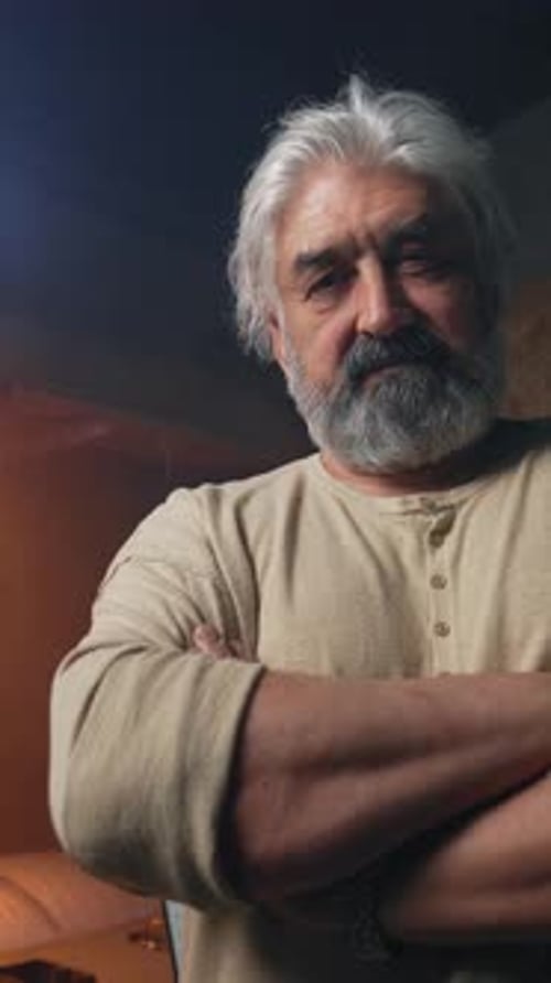 Confident Mature Man with Arms Crossed in Workshop