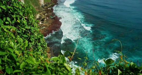 Scenic pristine green beach on Bali island for summer holiday vacation. Beautiful blue Balinese sea