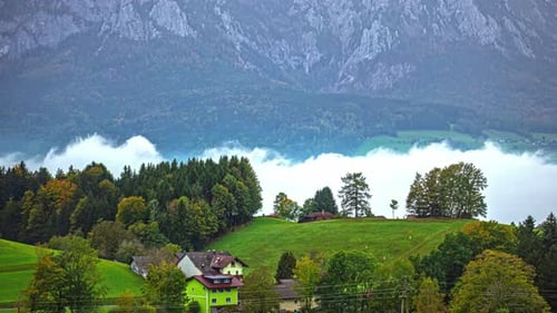 Central Alps, Austria, Europe - An Austrian Hamlet Nestled Beneath the Alps, Blanketed by Low-lying