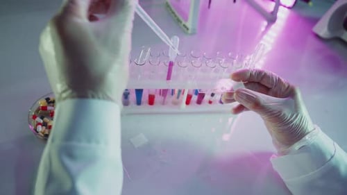 Lab Technician Works on a Sample Under Bright Light