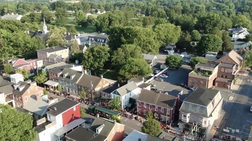 Aerial truck shot of floats in historic restored residential district, Lititz Lancaster County, Penn