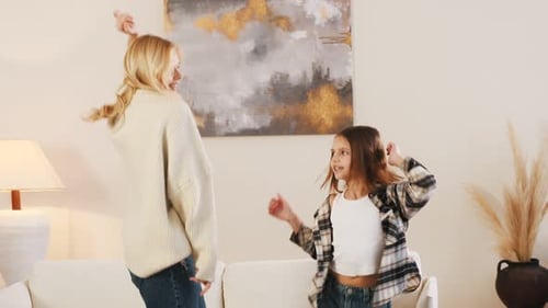Mother and Daughter Dancing Together Happily at Home