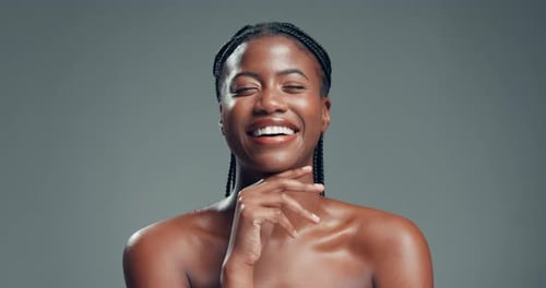 Laugh, happy and skincare with face of black woman in studio for self care, beauty and shine