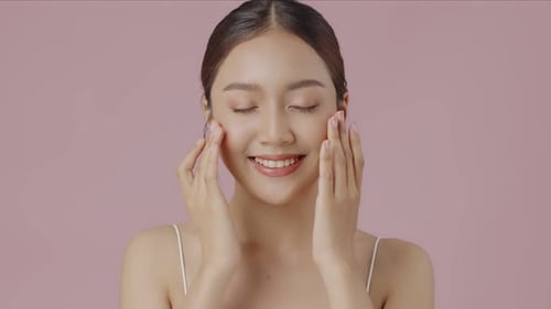 Young Asian woman feeling fresh with clear smooth skin.