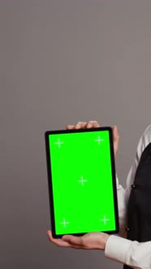 Vertical Video Asian Restaurant Hostess Showing Greenscreen Display in Studio