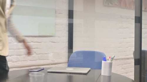 Man Opens Laptop and Starts Typing in Office