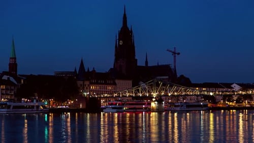 Serene Frankfurt Nighttime Scene with Glowing Lights on Water