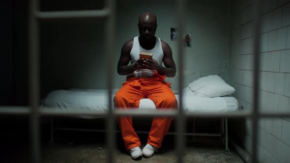 Inmate Sitting in Prison Cell and Reading Prayer in Bible, People Stock ...