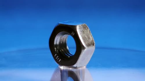 Shiny Metal Nut Rotating in Close Up