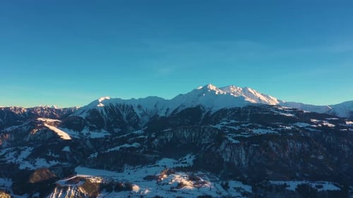 Aerial top view of snowy forest and winter in mountains and famous winter ski resort aerial view. Wi