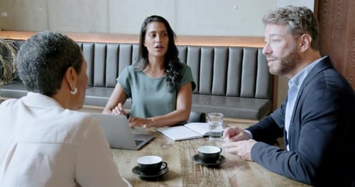 Team of Businesspeople having a Meeting in a Restaurant