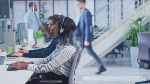 Team Working at Computers in Modern Bright Office