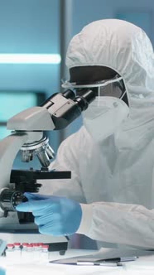 Scientist Works with Microscope in a Laboratory