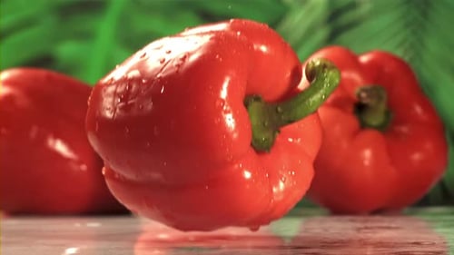 Red Bell Pepper Falls on a Wet Table Filmed on a Highspeed Camera at 1000 Fps