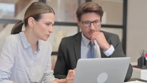 Close up of Businessman with Female Partner Working on Laptop
