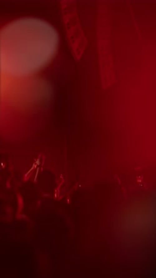 Crowd Enjoying Concert with Colorful Stage Lighting