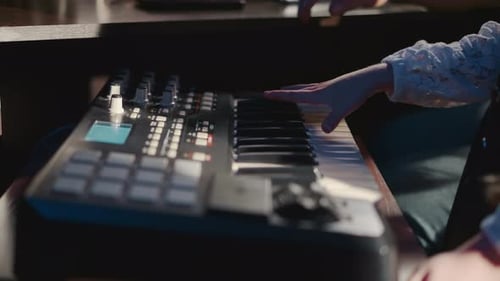 Child Plays Synthesizer with Teacher in Studio