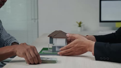 Business people seller explain and calculate to who buying real estate house properties.