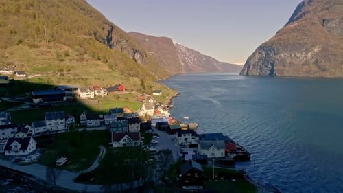 Slow motion aerial over small fisher village on the coast of a fjord in Norway