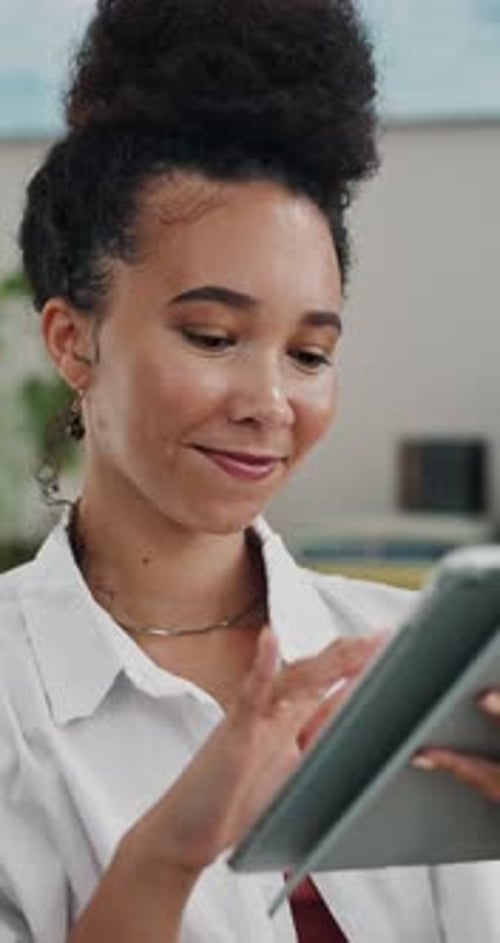 Smiling Woman Using Tablet Device in Modern Office