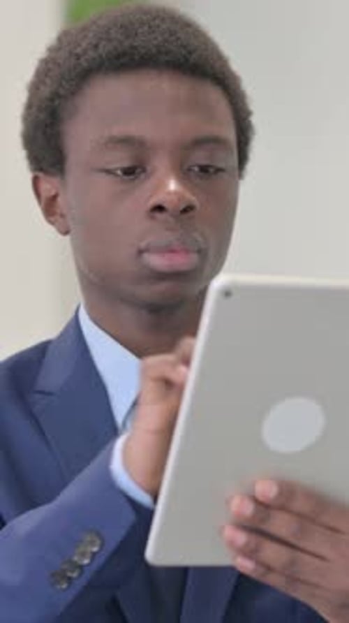 Young Man Working on Tablet Device Indoors