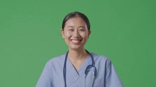 Close Up Of Asian Female Doctor With Stethoscope Walking On Green Screen Background