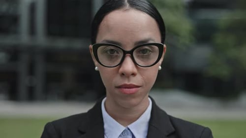 Young Woman in Business Clothes Looking at Camera