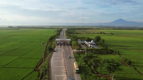 Aerial View of Highway Toll Booth among Rice Fields