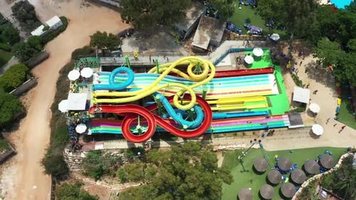 Aerial view of people sliding down a water slide at a water park