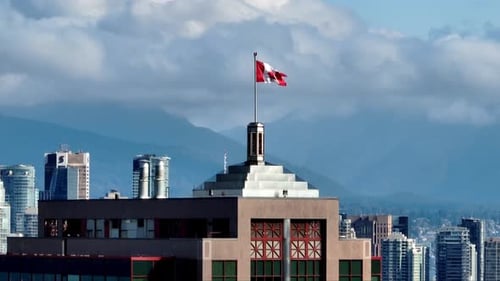 Canadian Flag On Top Of High-rise Building In Downtown Vancouver Skyline. Vancouver Lookout Revealed