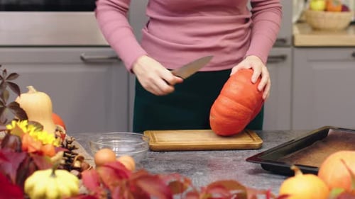 Hands Cutting Orange Ripe Raw Pumpkin Peel Remove Pumpkin Seeds with Spoon for Thanksgiving