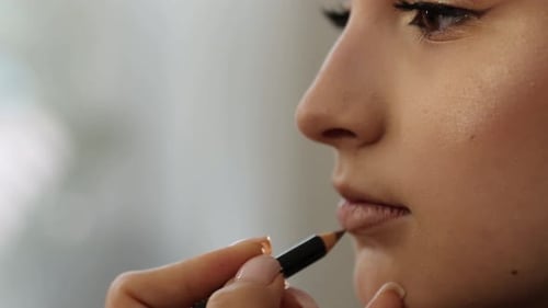 Woman Applying Lip Liner for Beautiful Makeup Look