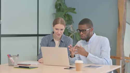 Young Business People Discussing Work in Office