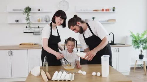 Family Cooking and Laughing Together in a Cozy Kitchen