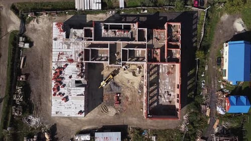 Vista superior de las grúas de construcción y el proceso de construcción de una nueva escuela en