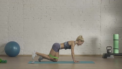 Woman Doing Donkey Kicks with Resistance Band
