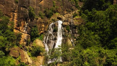 A Tropical Waterfall in a Mountain Canyon Surrounded By Jungle