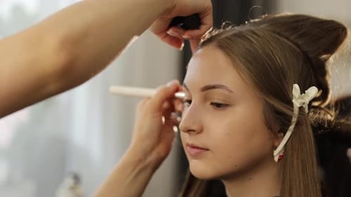 Beautiful Young Woman Receiving Professional Makeup to Achieve a Remarkable Look