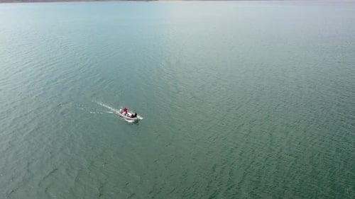 Aerial View Of People Cruising By Boat On The Lake 22