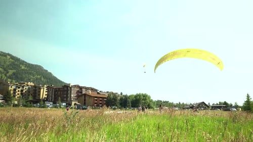 Parachute landing in golden field near teton village Wyoming USA flight shot